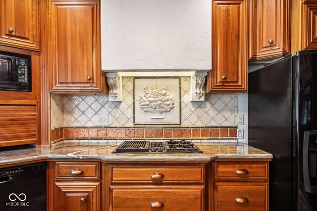 6902 Creekridge Trl, Indianapolis, IN 46256 - kitchen with black appliances, tasteful backsplash, light stone counters, and brown cabinets