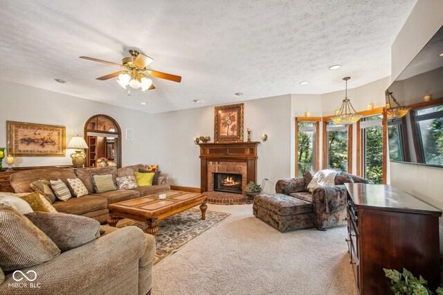 6902 Creekridge Trl, Indianapolis, IN 46256 - living room with light carpet, a brick fireplace, ceiling fan, a textured ceiling, and recessed lighting