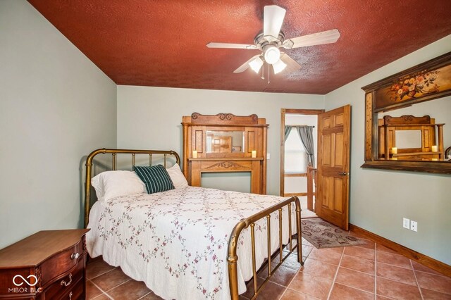 6902 Creekridge Trl, Indianapolis, IN 46256 - tiled bedroom featuring a textured ceiling, baseboards, and ceiling fan