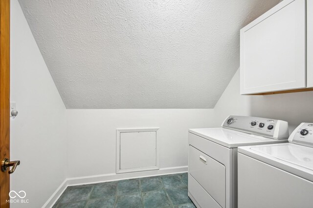 6902 Creekridge Trl, Indianapolis, IN 46256 - washroom with washing machine and clothes dryer, a textured ceiling, baseboards, and cabinet space
