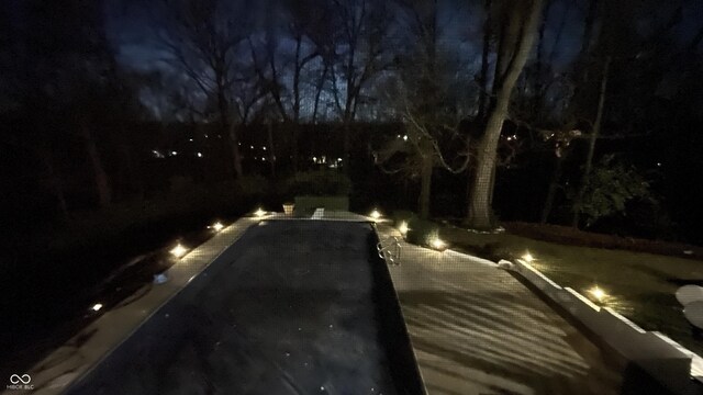view of pool at night