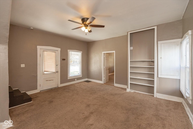 unfurnished bedroom featuring a ceiling fan, baseboards, and carpet floors