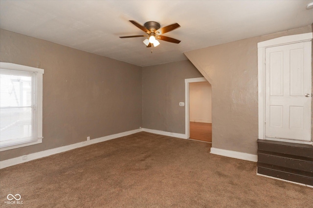 interior space with a ceiling fan, baseboards, and carpet floors