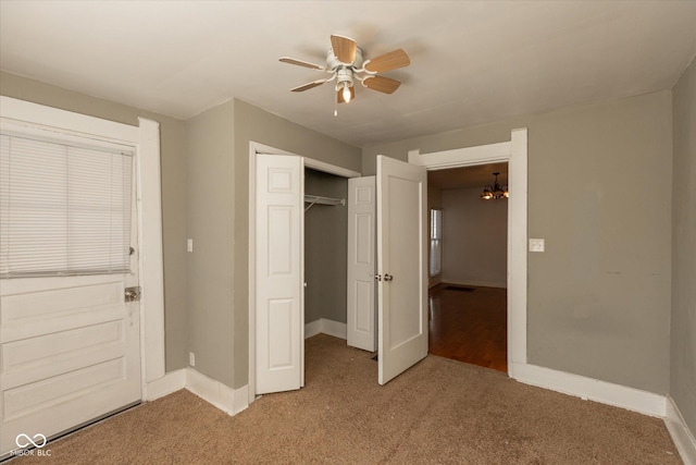 unfurnished bedroom featuring a ceiling fan, visible vents, baseboards, a closet, and light colored carpet