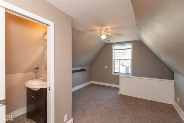 bonus room with lofted ceiling, carpet, baseboards, and a sink