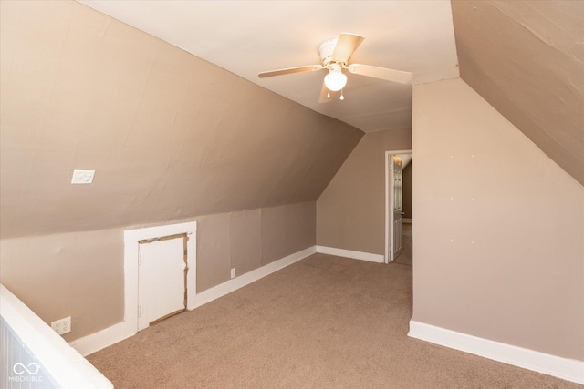 additional living space with baseboards, light carpet, lofted ceiling, and a ceiling fan