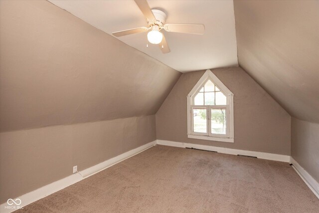 bonus room with visible vents, lofted ceiling, carpet floors, baseboards, and ceiling fan