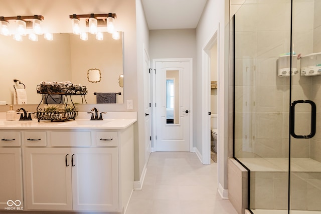 bathroom featuring vanity, tile patterned floors, toilet, and walk in shower