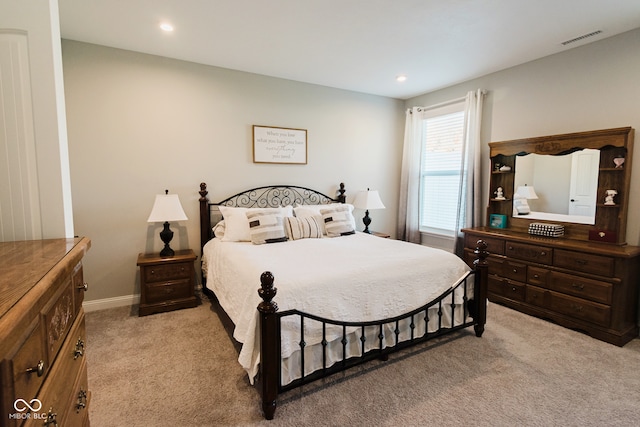 bedroom featuring light colored carpet