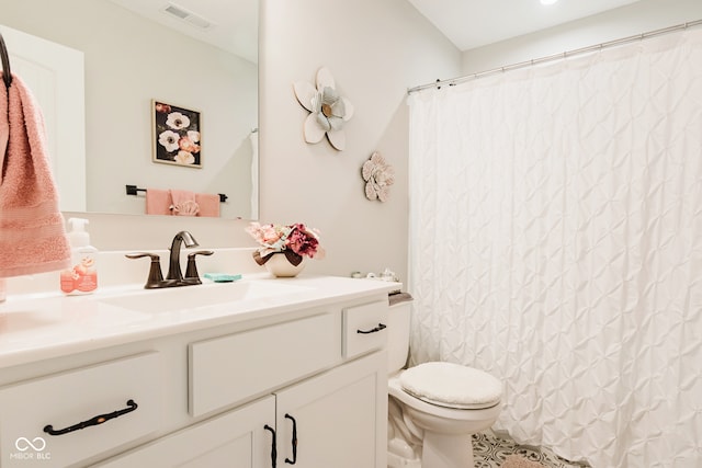 bathroom with vanity, walk in shower, and toilet