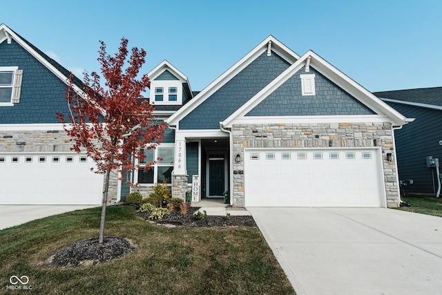 craftsman inspired home featuring a front yard and a garage