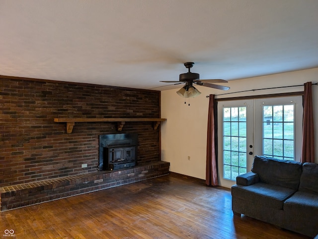 unfurnished living room featuring french doors, wood-type flooring, a wood stove, and ceiling fan