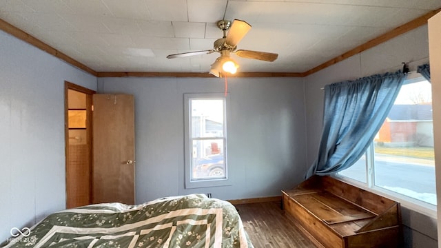 bedroom with hardwood / wood-style flooring, crown molding, and ceiling fan