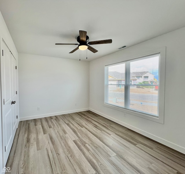 unfurnished room with ceiling fan and light hardwood / wood-style floors