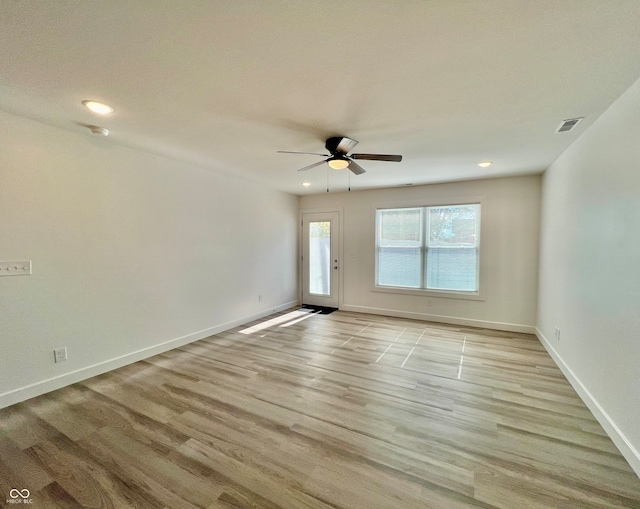 spare room with light wood-type flooring and ceiling fan