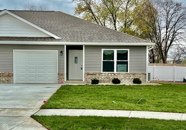 view of front of home with a garage and a front yard