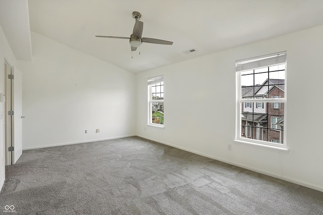 spare room featuring lofted ceiling, carpet flooring, and ceiling fan