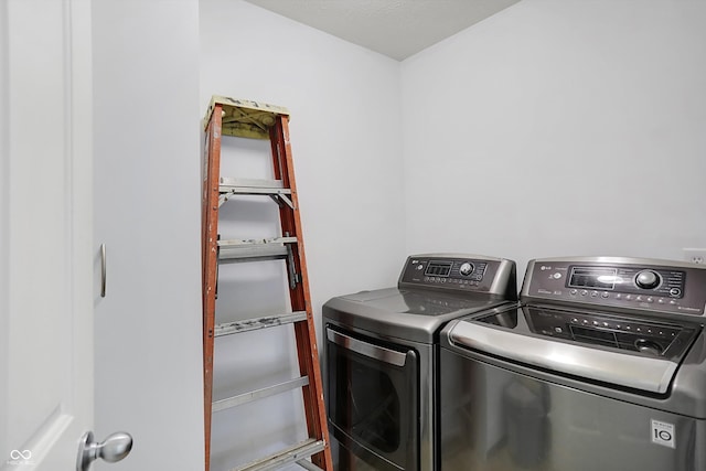 laundry area with washing machine and clothes dryer