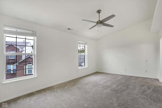 spare room featuring carpet flooring, vaulted ceiling, and ceiling fan