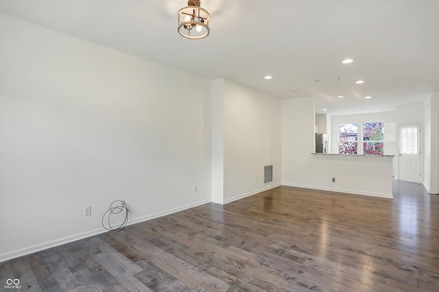 spare room with dark wood-type flooring