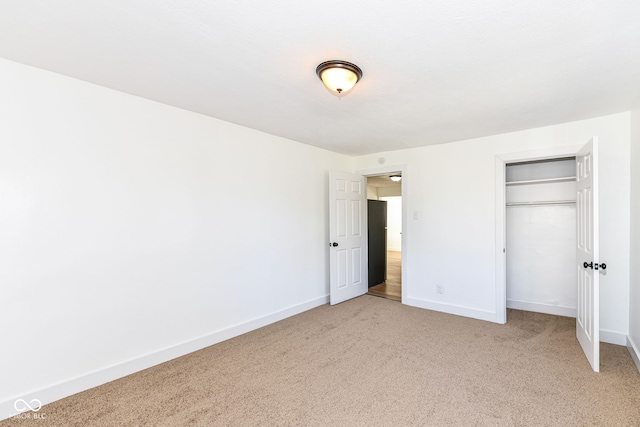 unfurnished bedroom with carpet floors and a closet