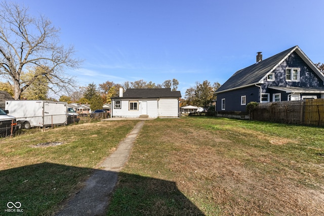 rear view of house featuring a lawn