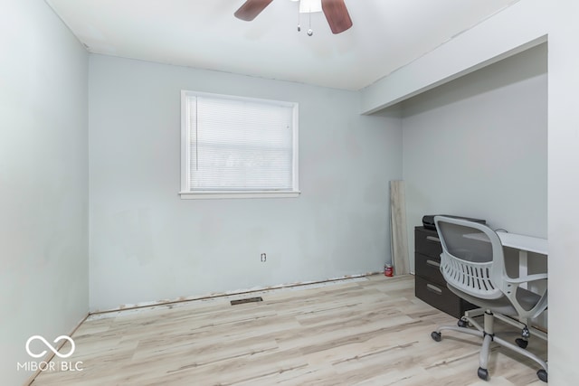 home office featuring light hardwood / wood-style floors and ceiling fan