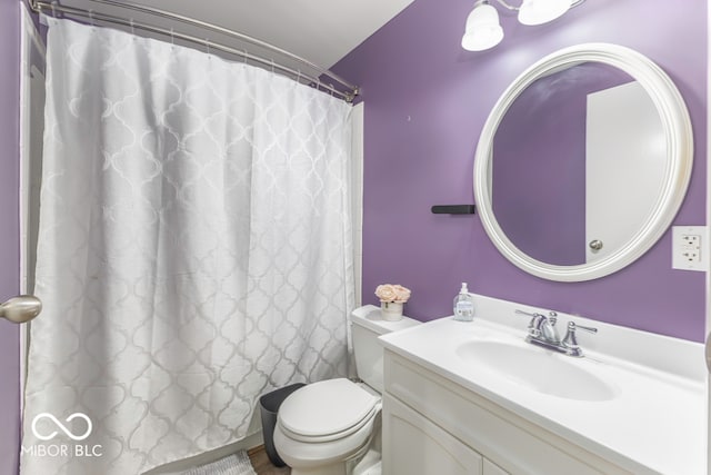 bathroom featuring vanity, toilet, and a shower with shower curtain