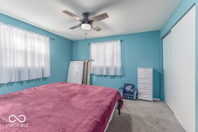 carpeted bedroom with a closet and ceiling fan