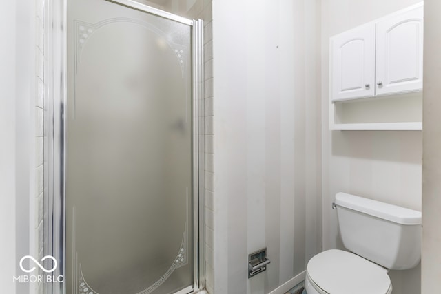 bathroom with toilet and an enclosed shower