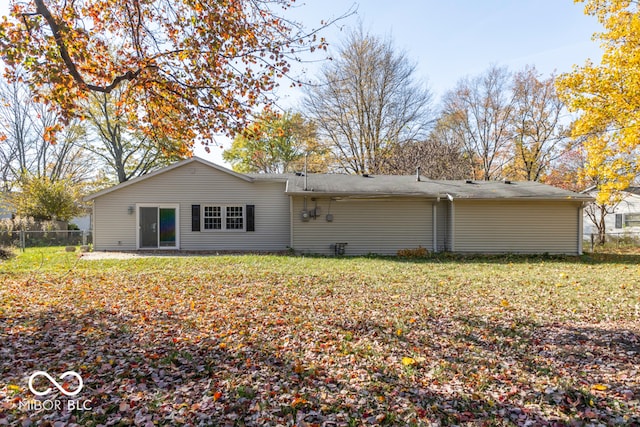 rear view of house with a yard