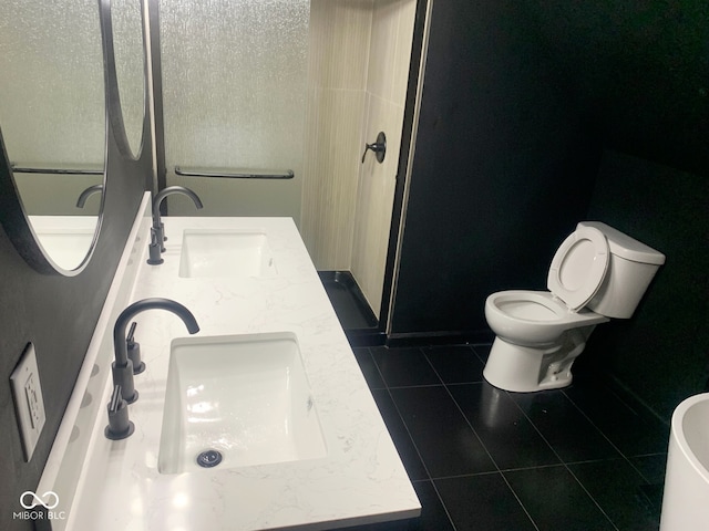 bathroom with vanity, toilet, and tile patterned floors