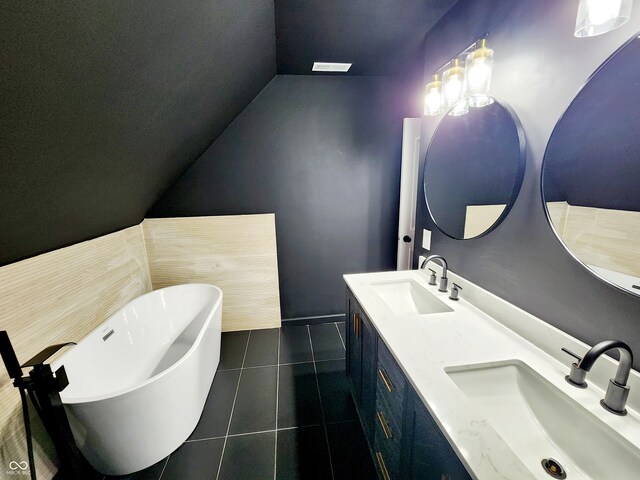 bathroom featuring vanity, a bathtub, and tile patterned flooring