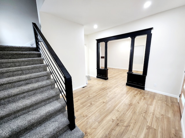 staircase featuring wood-type flooring