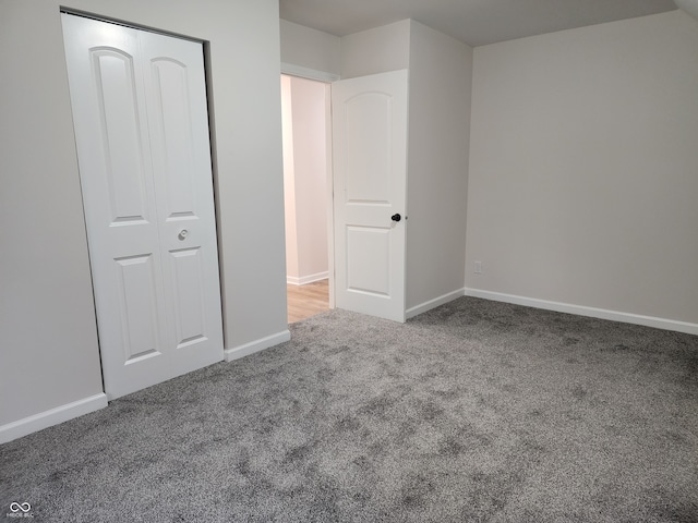 unfurnished bedroom featuring a closet and carpet floors