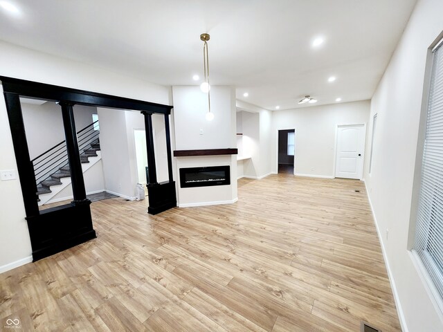 unfurnished living room featuring light wood-type flooring