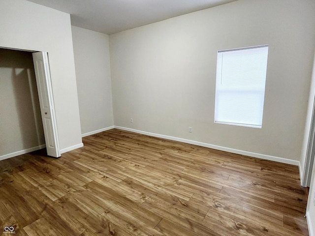 unfurnished bedroom featuring a closet and light hardwood / wood-style flooring