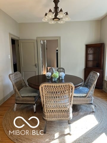 dining room featuring hardwood / wood-style flooring and a notable chandelier