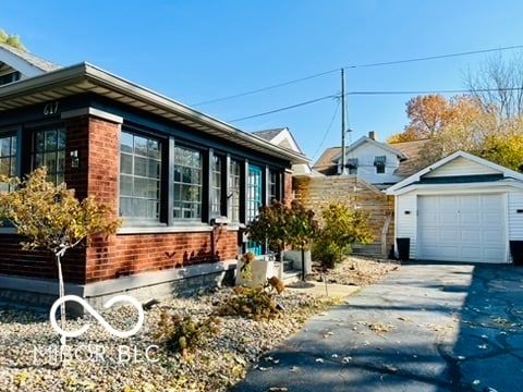 view of side of home with a garage and an outdoor structure