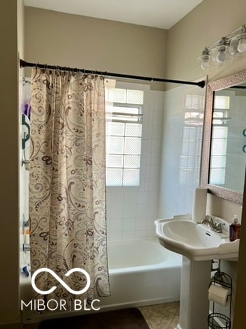 bathroom with tile patterned floors and shower / bath combo