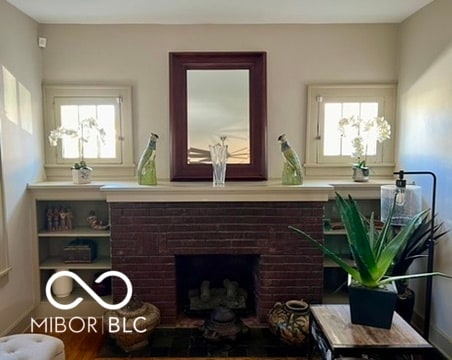 interior space featuring hardwood / wood-style flooring and a brick fireplace