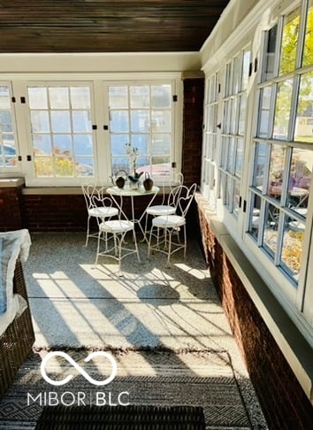 sunroom / solarium featuring wooden ceiling