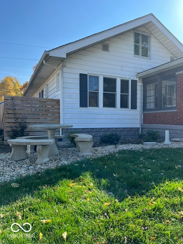 view of home's exterior with a lawn