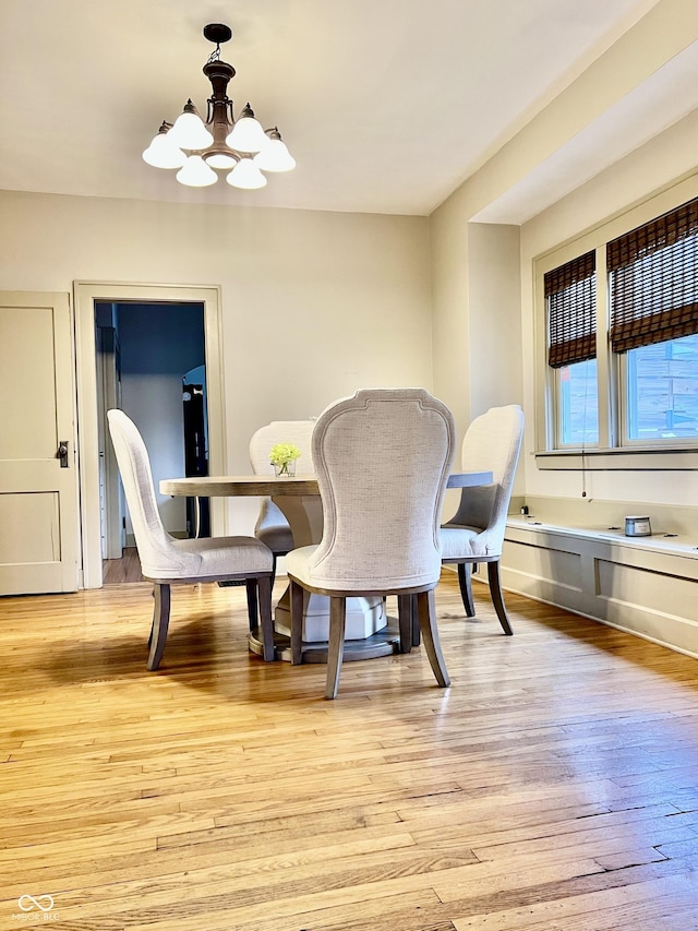 dining room featuring a chandelier and light hardwood / wood-style flooring