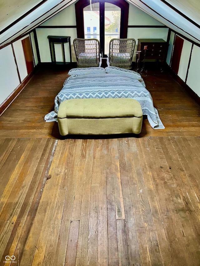 bedroom featuring lofted ceiling and hardwood / wood-style floors