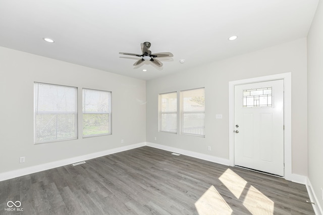 foyer with ceiling fan and dark hardwood / wood-style flooring