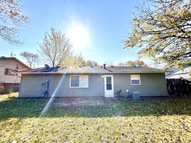 back of property featuring a yard and cooling unit