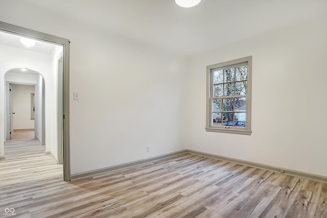 empty room with light hardwood / wood-style flooring