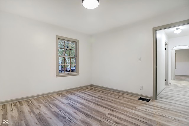 spare room with light hardwood / wood-style flooring