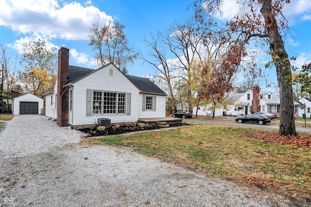 view of side of home featuring an outbuilding, a garage, and central AC